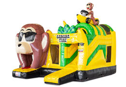Opblaasbaar springkussen met obstakels erin en een glijbaan in bananen apen thema te koop