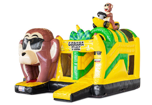 Opblaasbaar springkussen met obstakels erin en een glijbaan in bananen apen thema te koop